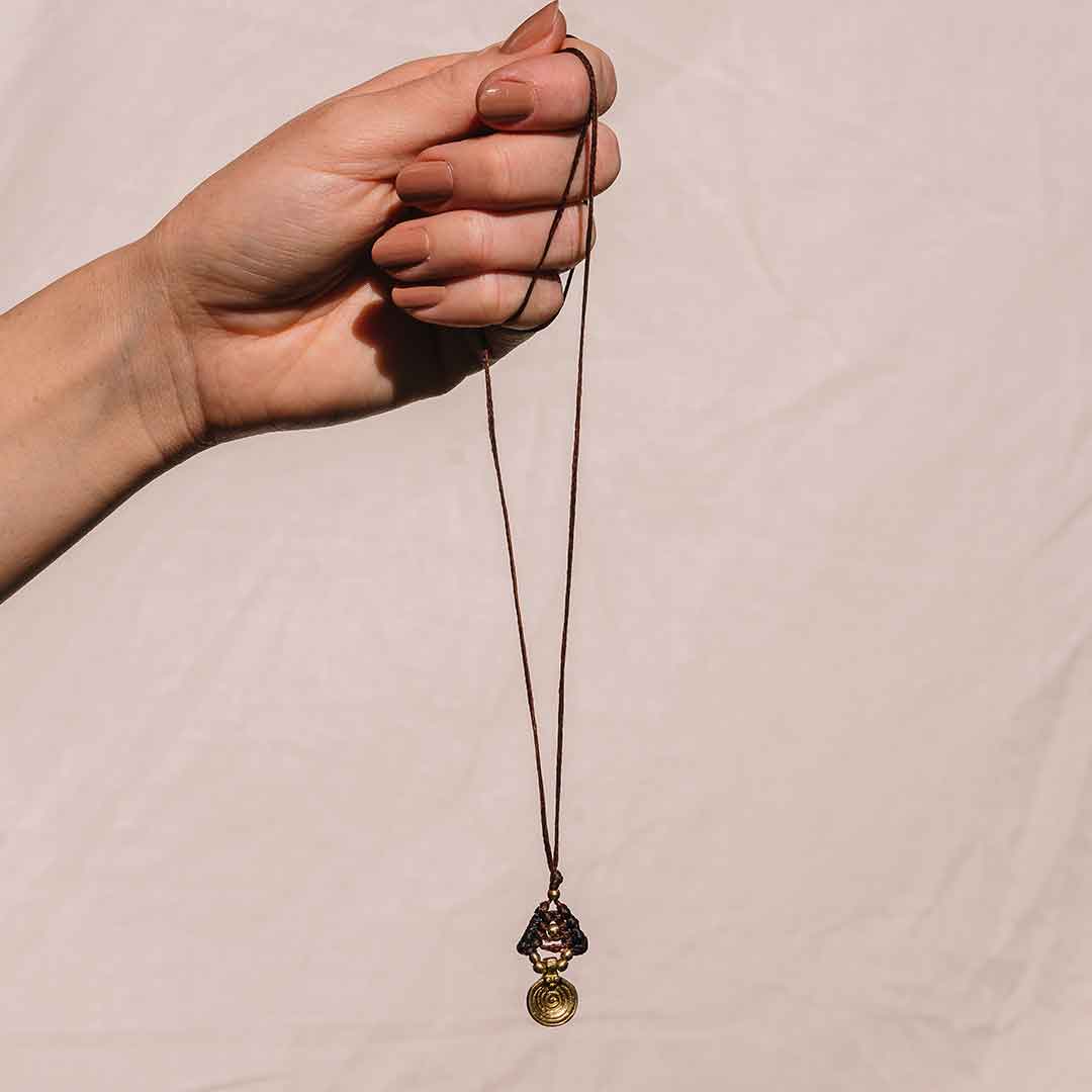 In diesem Bild wird die Makramee Kette von einer Hand gehalten.